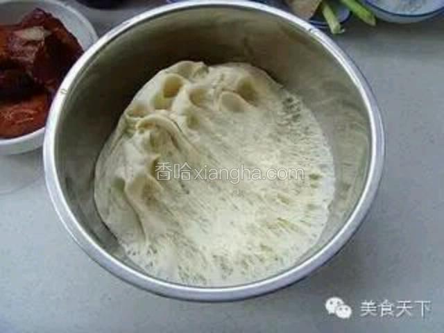 2、面粉加入酵母水和成软面团，包上保鲜膜发酵至原来的1.5倍到2倍大，呈现蜂窝状；用手轻轻将面团挤压排除气泡。

