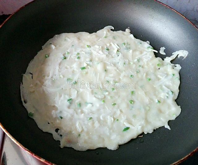 平底锅预热入少量花生油，油温热后倒入两勺浆糊摊平