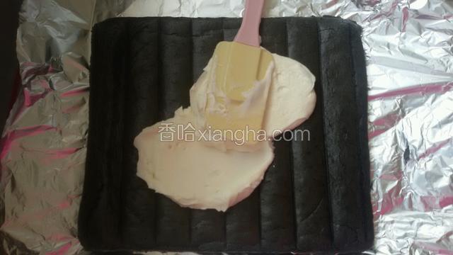 然后把打发好的淡奶油抹在放凉的竹炭蛋糕坯上