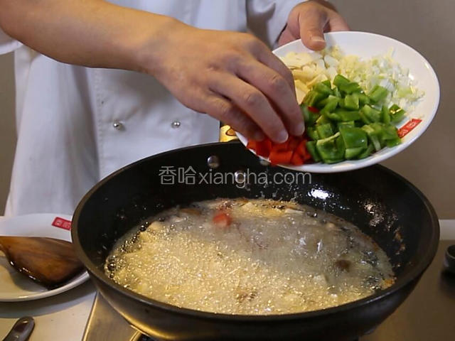 青椒、红椒用热油氽一下，焯熟倒入漏勺备用。
