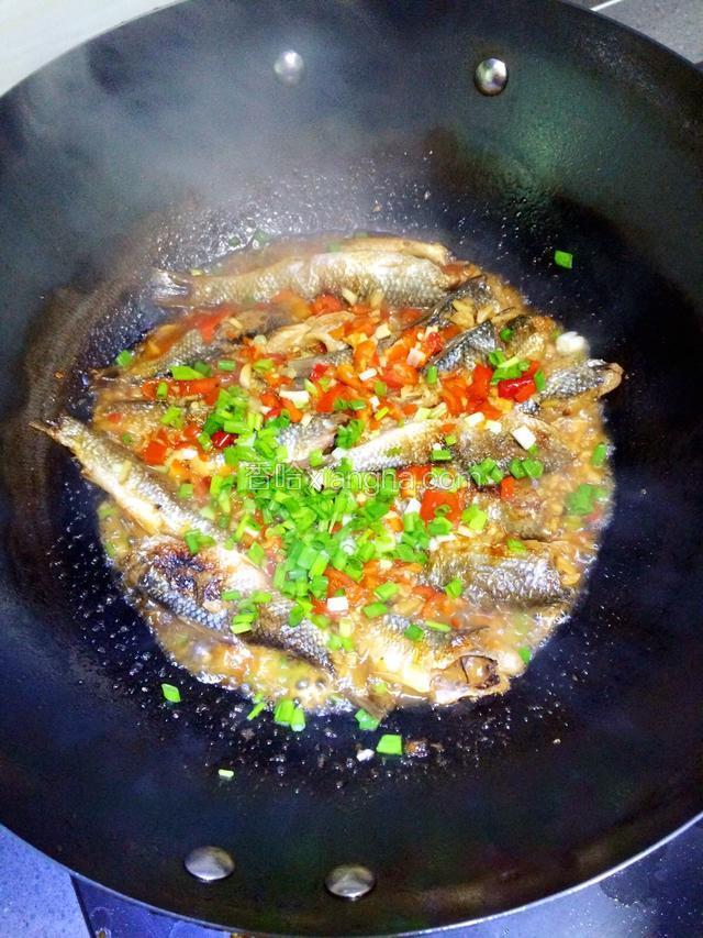 等汤汁快收干时，鱼干己入味，放入香油和葱花翻炒片刻即可出锅。