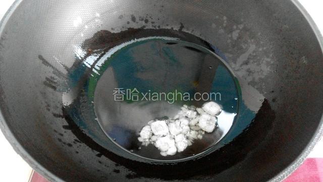 锅中放适量油烧热后改小火，放入冰糖用铲刀划炒至冰糖完全融化。