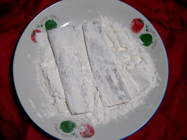 用筷子夹着带鱼，正反面粘上面粉。