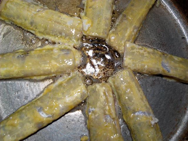 锅里倒入油，油烧到六七成热，放入带鱼煎至。