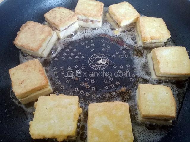 锅中加底油，把蘸上鸡蛋液的豆腐在锅中煎制。