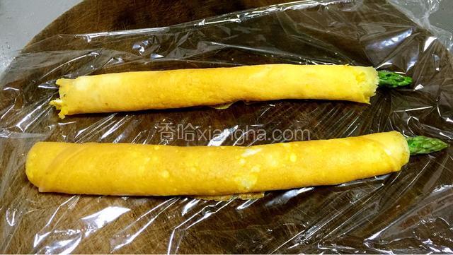 卷好的蛋皮放铺好保鲜膜的粘板上，切2厘米宽大小。