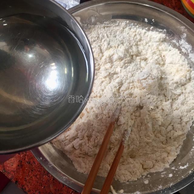在加入适量的（温水）用筷子搅拌成雪花状（水一定要间接加，面粉的吸水性都不一样，所以水的量要看情况加）