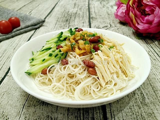 A、凉面放入盘中，铺上黄瓜丝、鸡丝、榨菜粒、花生、葱花。再淋上调味汁拌匀就可以吃了。(但是通常拌不均匀哈)。