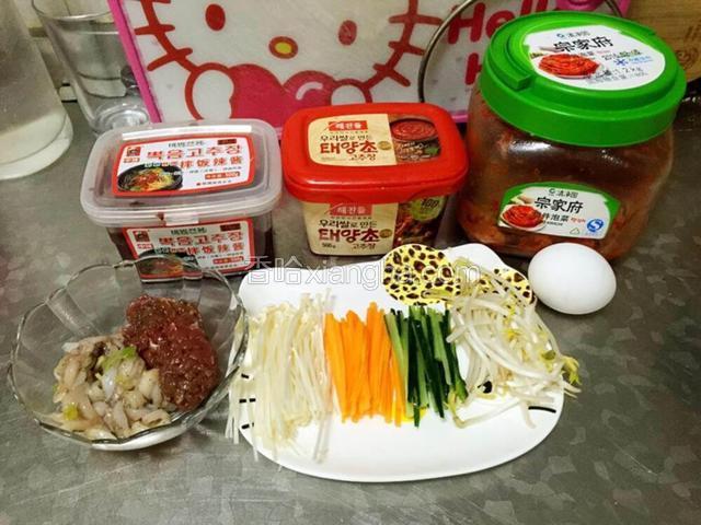 黄瓜，胡萝卜切丝，不要切太细，所有配菜切长度一样最好
拌饭所用的酱就是图里的2种酱，左手边是拌饭酱，微微辣，基本小朋友可以接受，中间的是辣酱，喜欢辣的可以加