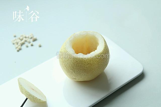 雪梨洗干净，切去上面四分之一处
用汤匙把雪梨心挖掉，小心别挖穿底部。
