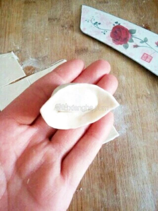 将下面两个角弯过来，叠加，捏紧即可。
