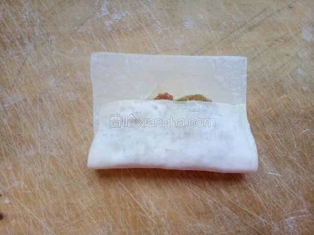 先盖上一端馄饨皮