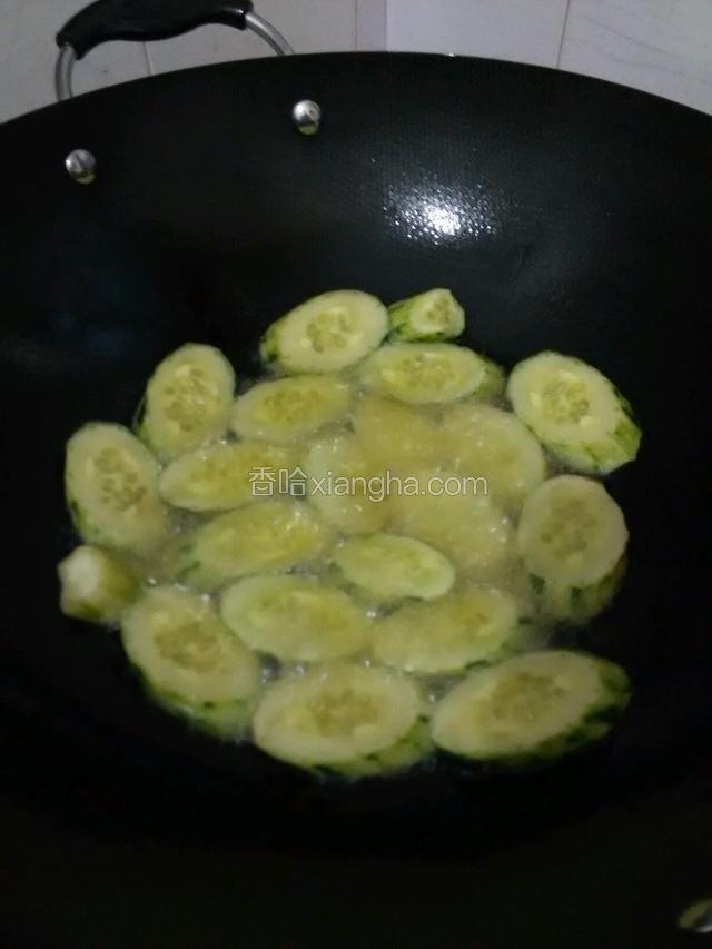 锅中放入充足的油大火烧热，放入黄瓜均匀铺在锅底煎