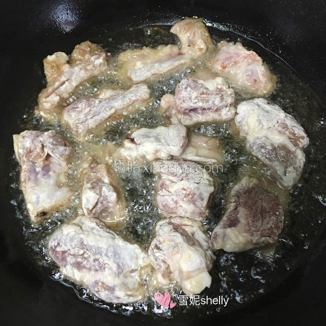 锅中入油，待七八成热的时候放入排骨炸至变色。