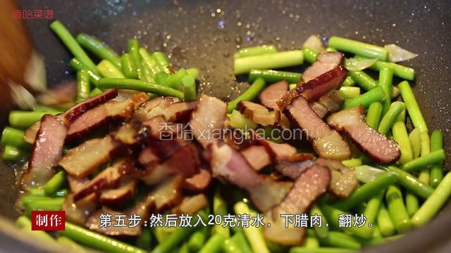 然后放入20克清水，将腊肉放入锅中继续翻炒