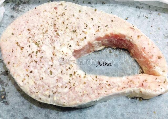 放入冰箱冷藏30分钟，让鱼入味。
提前预热烤箱200度。从冰箱取出腌好的三文鱼，表面撒少许披萨草和蒜末，入烤箱烤20分钟左右。