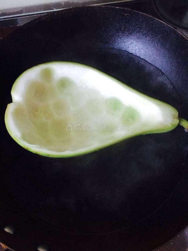烧一锅开水，水中加一点盐和油，把挖空的西葫芦皮放入锅中焯水5分钟后，倒入凉白开水中凉一下，入盘备用。