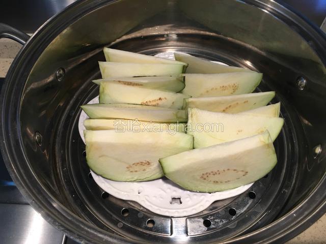 把茄子捞出来，放入带孔的盘子里，凉水入屉，水开后蒸15～20分钟。