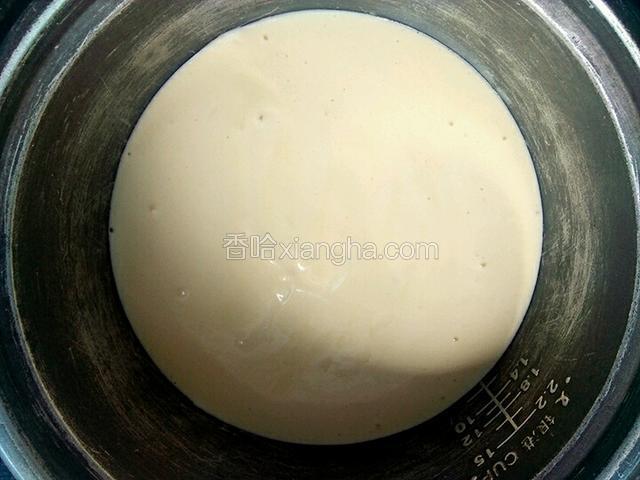把面糊倒进电饭锅里，电饭锅在桌子上掂两下震出大一点的气泡
