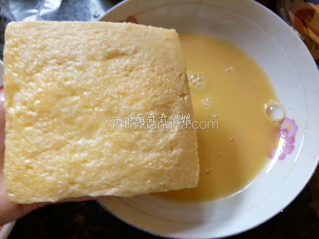 不粘平底锅倒入少许食用油烧热，把重叠好的土司在蛋液里裹一圈，六面都裹匀。