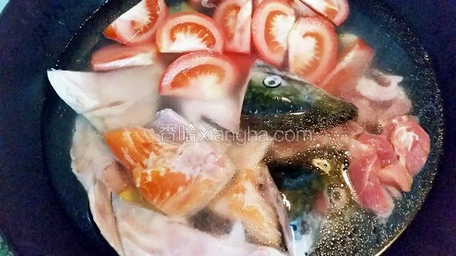 接着下三文鱼头、番茄和切片的瘦肉，水沸后煲40分钟