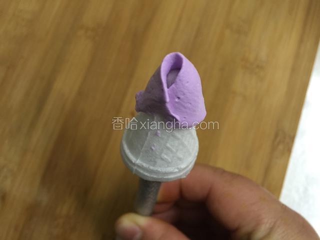 裱花棒用尖尖的那头.米托粘一点奶油.牢固一下插在裱花棒上.花嘴小口向上.花嘴贴住米托向右倾斜45度角.挤奶油手挽从下向上转一圈..同时花棒自然转动..把花心包住