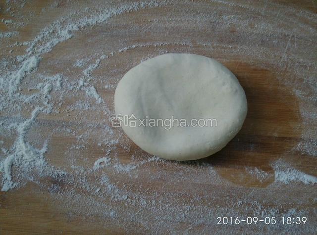 把面团压成饼状。