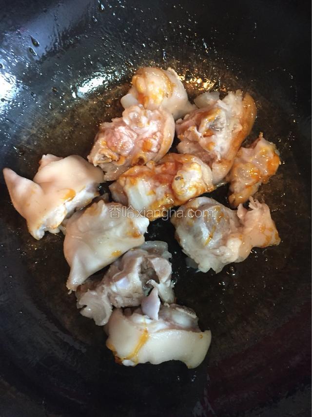 倒入猪蹄炒出红色。