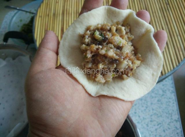 手掌托住面皮，馅料放中间