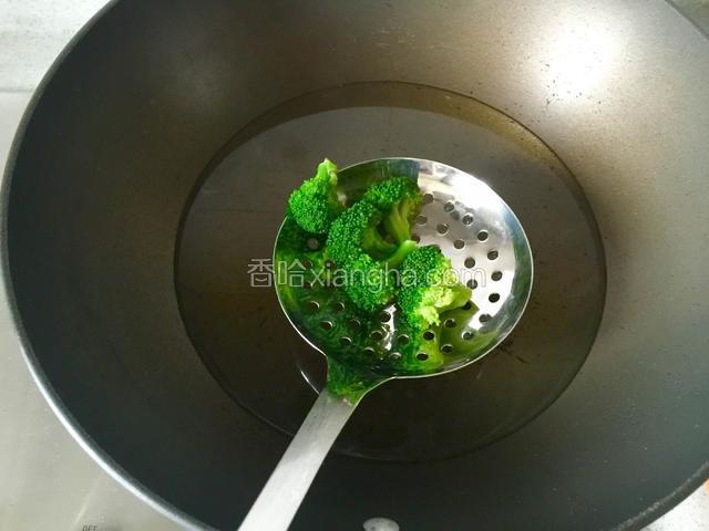用漏勺将焯熟的西兰花捞出，沥干水分待用；