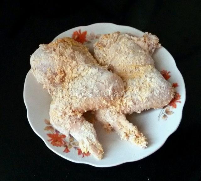 然后把面包糠混合，均匀的沾在腌好的鸡翅上。