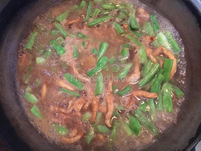 加入扁豆翻炒均匀后，倒入适量开水，以没过扁豆为宜，加入适量盐调味，盖上锅盖焖至扁豆7-8成熟。