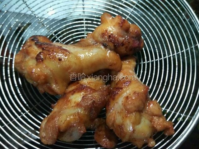小火慢炸，用笊篱不停的翻动鸡腿炸熟捞出控油。