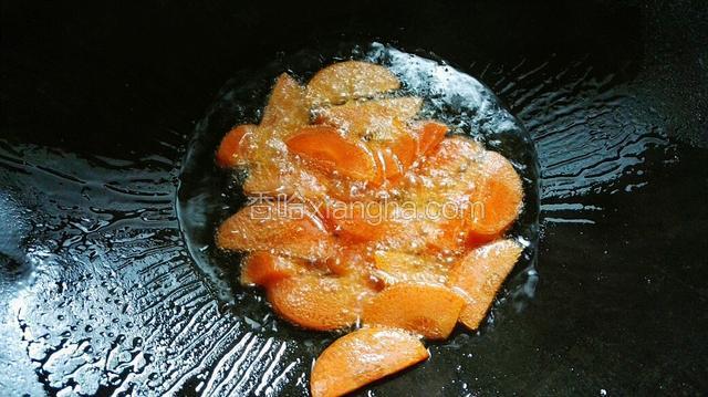 锅烧热，倒入适量的油，微热放入胡萝卜。
胡萝卜要先炒，才能把它胡萝卜素炒出来。