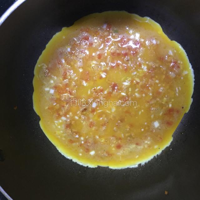 倒入鸡蛋液，等快要凝固时将 它卷起来