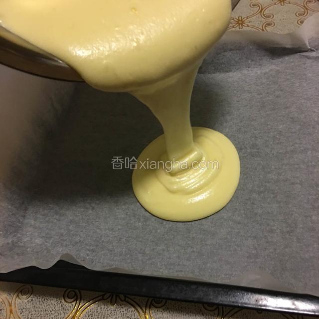 将制作好的蛋糕湖均匀倒在垫好油纸的烤盘上，将蛋糕湖摊匀