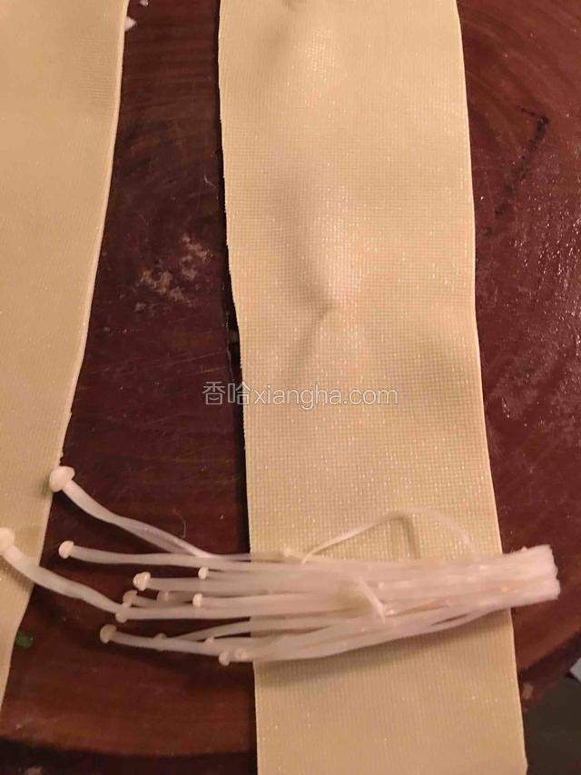 豆皮洗干净后，用刀切成大概宽度和金针菇长度一半的长条备用