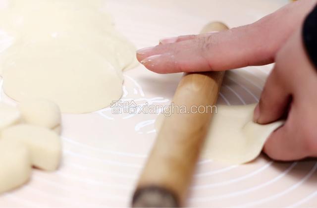 面团分成20份15克的剂子。像平常擀饺子皮一样把剂子擀成薄片，每片大小基本一致。