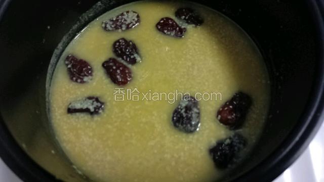 半小时后，粥已煮好，打开盖，用勺子搅拌均匀。