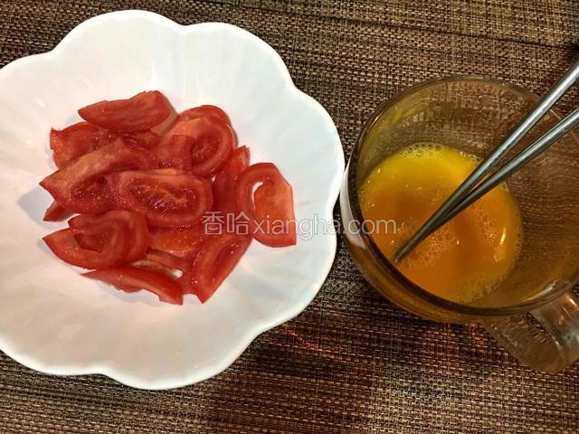 西红柿洗净切成小块，鸡蛋打入碗中，加少许清水搅拌均匀
