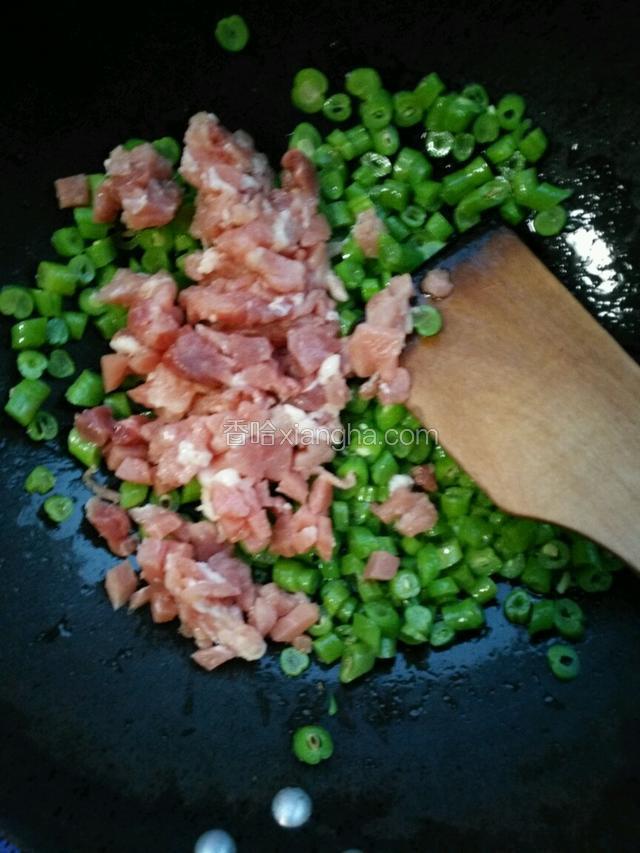 放入肉丁，继续翻炒。