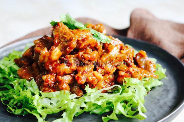 羊肉盛入盘中，香菜叶点缀，香喷喷的孜然羊肉就做好了。