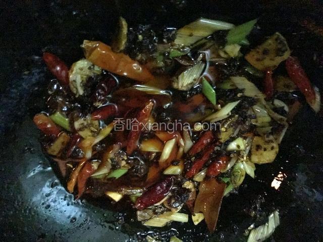 5.加入牛油火锅底料小火炒至融化，加入干辣椒段，花椒，八角，香叶，草果，肉蔻，花椒，麻椒小火炒香
