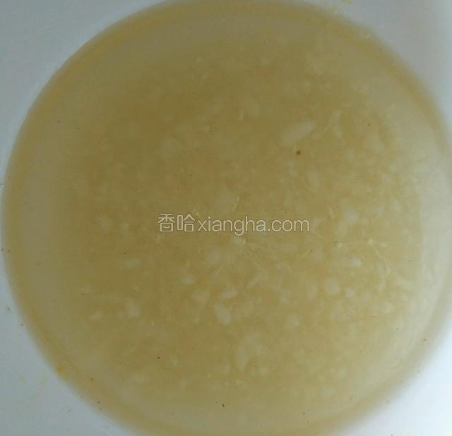 把面和好后，盖上盖子或用保鲜膜盖上，醒一个小时，在这期间可以剥蒜，把蒜切成这种蒜末，在给刚才切好的蒜末里加点水，将烧热的油泼在上面