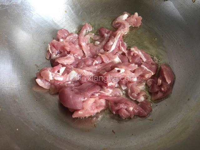 锅内放油烧至五成热，放入肉丝翻炒。
