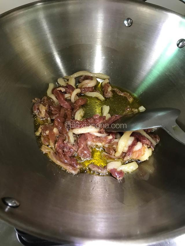 锅内倒入适量的油、7成热下肉丝划散，中火翻炒。