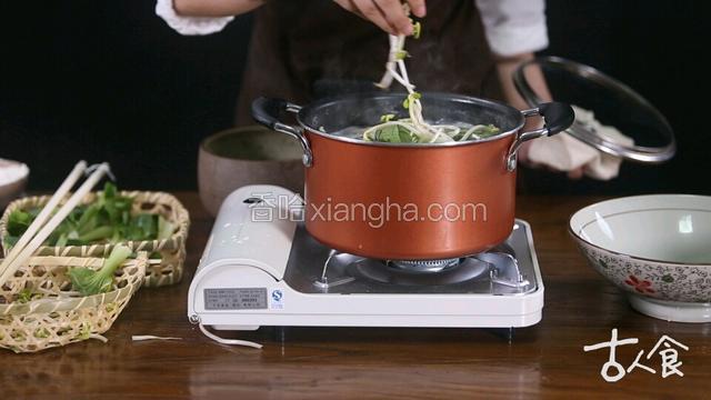 5、面条下入开水锅中煮，锅开后添加两次冷水并中途放入洗净的小白菜和豆芽，大火煮开至熟。
 