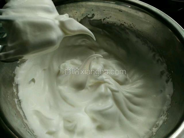然后分三次加入细砂糖，用电动打蛋器画圈式搅打蛋白，如图，直到蛋白打出小弯钩。