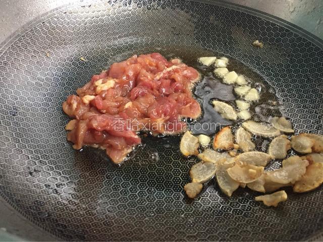 先后加入大蒜和肉翻炒
