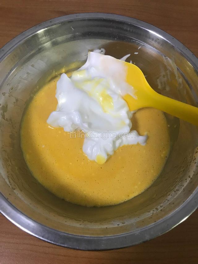 用橡皮刮刀取三分之一蛋白到蛋黄盆里，轻轻翻拌，就像炒菜一样，不要打圈圈搅拌，容易消泡